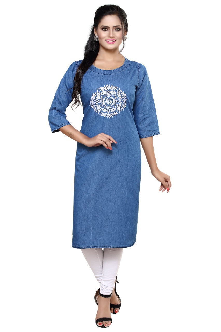 A woman modeling a blue denim-style straight kurta with three-quarter sleeves and a white printed mandala design on the chest, paired with white leggings and black sandals against a plain white background.