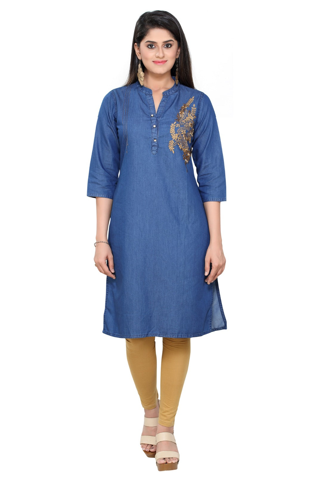A woman modeling a blue cotton kurta with gold embroidery on the chest, paired with mustard yellow leggings and beige sandals, against a plain white background.