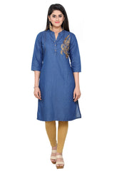 A woman modeling a blue cotton kurta with gold embroidery on the chest, paired with mustard yellow leggings and beige sandals, against a plain white background.