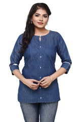 A woman modeling a blue denim-style kurta with vertical wavy embroidery and silver button accents, paired with blue jeans, against a plain white background.