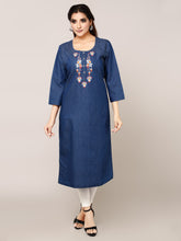 A woman modeling a blue three-quarter sleeve kurta with white and red embroidered details on the chest, paired with white leggings and black sandals, against a solid light gray background.