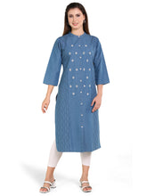 Woman wearing a blue kurta with white patterns on a white background