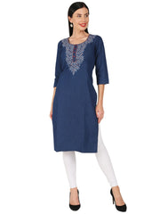 A woman modeling a navy blue kurta with white embroidered detailing around the neckline, paired with white leggings and black heels, against a plain white background.